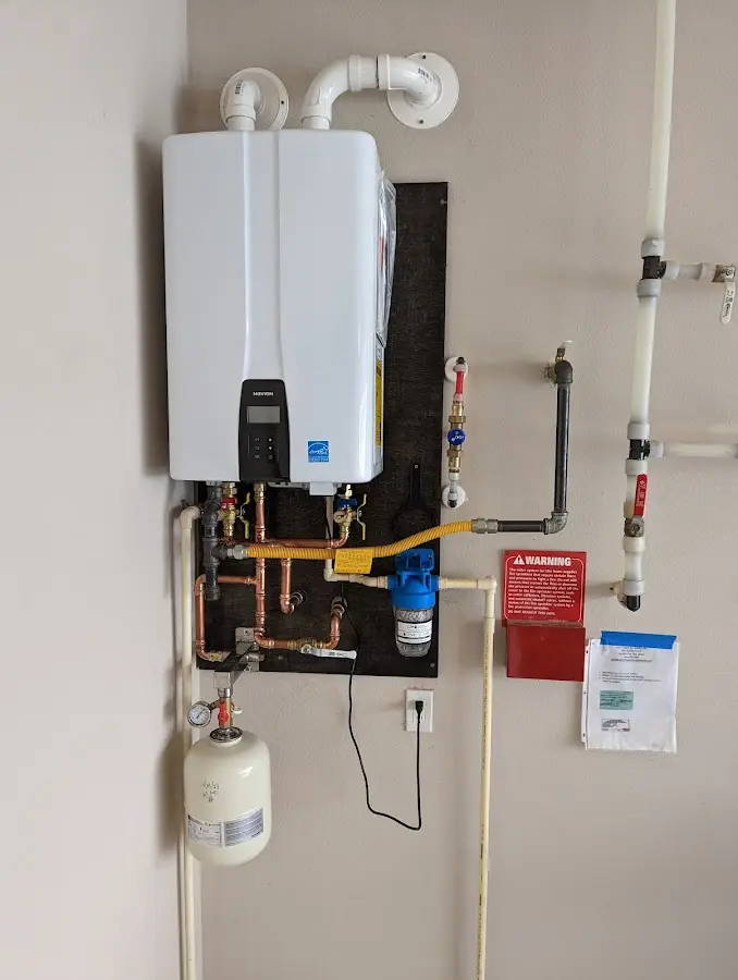 Professional plumber installing copper piping in a Holden home